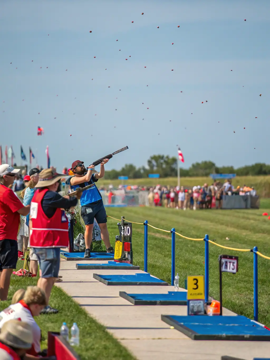 A vibrant image of a ball-trap shooting event organized by ATSK, capturing the excitement and community spirit, with participants actively engaged in the sport.